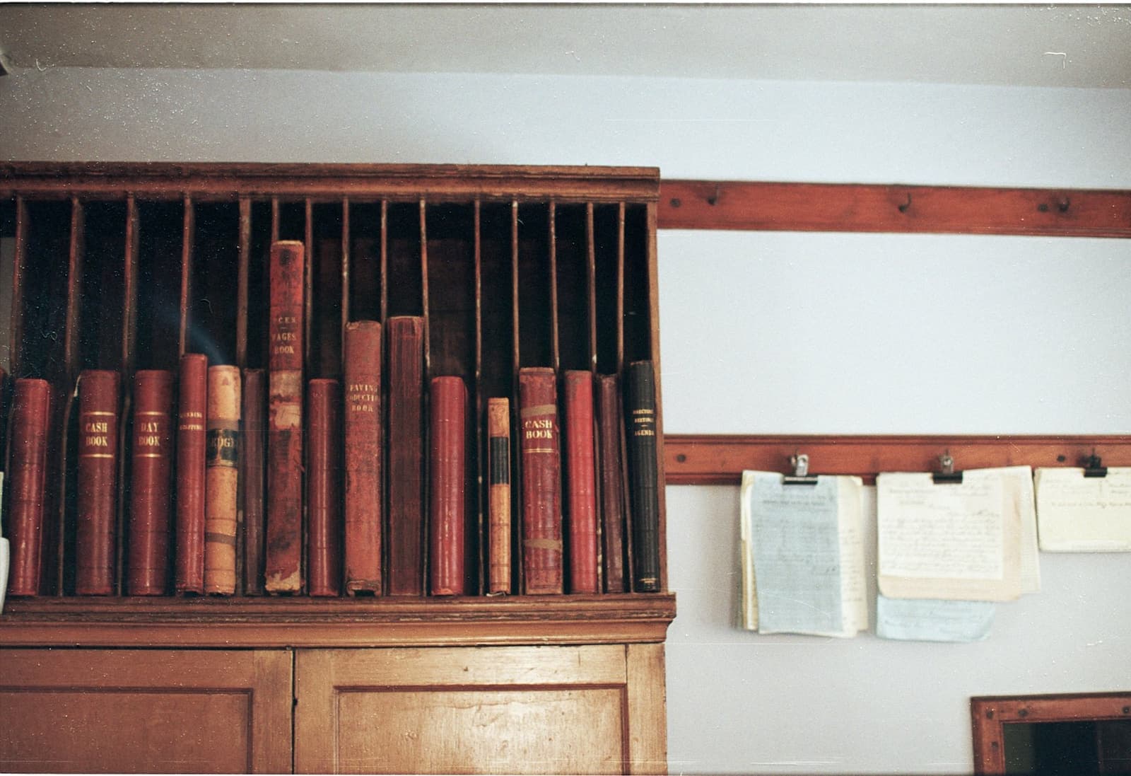 Leather-bound registers on a shelf